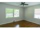 Bedroom features hardwood floors, two large windows and a ceiling fan at 1468 North Amanda Cir, Atlanta, GA 30329