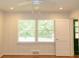 Bedroom with paneled walls and views of the yard through the large windows at 1468 North Amanda Cir, Atlanta, GA 30329