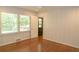 Light bedroom with wood floors, paneled walls and backyard view through the large windows at 1468 North Amanda Cir, Atlanta, GA 30329