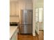 Stainless steel refrigerator, white cabinets and subway tile backsplash in this kitchen at 1468 North Amanda Cir, Atlanta, GA 30329