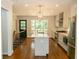 Bright kitchen with stainless steel appliances, white cabinets and a kitchen island with hardwood floors at 1468 North Amanda Cir, Atlanta, GA 30329