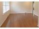 Large living room with hardwood flooring, natural light, and crisp white walls at 1468 North Amanda Cir, Atlanta, GA 30329