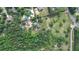 Aerial view of the property boundaries with a house, workshop, mature trees, and a large grassy field at 2100 Highway 138 E E, Stockbridge, GA 30281