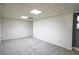 A large basement area featuring carpeted floors, white walls and a window with a curtain panel at 2100 Highway 138 E E, Stockbridge, GA 30281