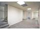 An unfinished basement area featuring carpeted flooring, white walls, and multiple doorways at 2100 Highway 138 E E, Stockbridge, GA 30281