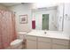 Bathroom with a toilet, white vanity, mirror, framed art, and shower with a decorative curtain at 2100 Highway 138 E E, Stockbridge, GA 30281