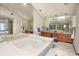 Primary bathroom featuring a large soaking tub, vanity, and mirrors at 2100 Highway 138 E E, Stockbridge, GA 30281