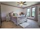 Comfortable bedroom features a ceiling fan, two large windows and a decorative, white wood bed frame at 2100 Highway 138 E E, Stockbridge, GA 30281