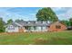 Ranch style home featuring a brick and grey painted exterior, dormer windows, and well maintained landscaping at 2100 Highway 138 E E, Stockbridge, GA 30281