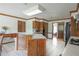 Spacious kitchen featuring wood cabinetry, an island with a sink, and a white tile floor at 2100 Highway 138 E E, Stockbridge, GA 30281