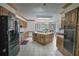Spacious kitchen featuring wood cabinetry, an island with a double sink, and a tile floor at 2100 Highway 138 E E, Stockbridge, GA 30281