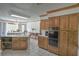 Bright kitchen featuring wood cabinetry, an island with a double sink, and a tile floor at 2100 Highway 138 E E, Stockbridge, GA 30281