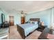 A spacious primary bedroom is shown with a ceiling fan and an abundance of furniture and decor at 2100 Highway 138 E E, Stockbridge, GA 30281