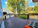 Spacious back deck with wood flooring and railing overlooking backyard area with mature trees at 1225 Creek Laurel Dr, Lawrenceville, GA 30043
