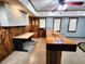 Basement bar with white cabinets, mini fridge, sink and rustic wood countertop at 1225 Creek Laurel Dr, Lawrenceville, GA 30043