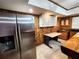 Bar area features stainless steel refrigerator, white cabinets, rustic walls and wood countertop at 1225 Creek Laurel Dr, Lawrenceville, GA 30043