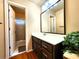 Bathroom featuring a large mirror, single sink vanity, tile flooring, and shower with glass door at 1225 Creek Laurel Dr, Lawrenceville, GA 30043