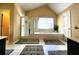 A luxurious bathroom features a garden tub, a separate shower, and dual sinks at 1225 Creek Laurel Dr, Lawrenceville, GA 30043