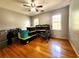 Bedroom with hardwood floors, ceiling fan, desk and storage containers, providing ample space at 1225 Creek Laurel Dr, Lawrenceville, GA 30043