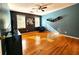 Bright bedroom with hardwood floors, ceiling fan, modern wall art and unique shelving at 1225 Creek Laurel Dr, Lawrenceville, GA 30043