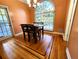 A charming dining area featuring hardwood floors, a modern light fixture, and a bright window for natural light at 1225 Creek Laurel Dr, Lawrenceville, GA 30043