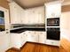 Bright kitchen with white cabinets, black countertops, and modern appliances at 1225 Creek Laurel Dr, Lawrenceville, GA 30043