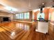 Open-concept living area with hardwood floors, brick fireplace, and kitchen island at 1225 Creek Laurel Dr, Lawrenceville, GA 30043