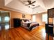 Spacious main bedroom with hardwood floors, decorative ceiling, and natural light from large windows at 1225 Creek Laurel Dr, Lawrenceville, GA 30043