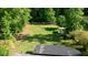 Aerial view of the expansive backyard with a fence and wooded perimeter at 3627 Groovers Lake Rd, Lithia Springs, GA 30122