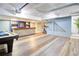 Spacious finished basement area featuring a pool table, bar area, light blue walls and sleek flooring at 3627 Groovers Lake Rd, Lithia Springs, GA 30122