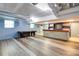 Finished basement with light blue walls, offering a bar area, pool table, and sleek, modern flooring at 3627 Groovers Lake Rd, Lithia Springs, GA 30122