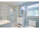 Modern bathroom with a walk-in shower, dual sinks, and contemporary design elements at 3627 Groovers Lake Rd, Lithia Springs, GA 30122