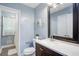 Bathroom with a white countertop, dark wood cabinets, a decorative mirror, and a shower behind a curtain at 3627 Groovers Lake Rd, Lithia Springs, GA 30122