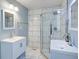 Modern bathroom featuring double sinks, white marble, and a glass-enclosed shower at 3627 Groovers Lake Rd, Lithia Springs, GA 30122