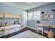 Charming bedroom featuring a wooden bunk bed, light blue walls, a modern desk, and a light gray rug at 3627 Groovers Lake Rd, Lithia Springs, GA 30122