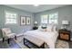 Comfortable bedroom featuring large windows, a luxurious bed with white linens, and stylish neutral decor at 3627 Groovers Lake Rd, Lithia Springs, GA 30122