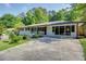 Ranch-style home featuring a vibrant blue front door, a cozy front porch, and a long driveway at 3627 Groovers Lake Rd, Lithia Springs, GA 30122