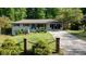 Charming single-story home with a well-manicured lawn and inviting curb appeal and long driveway at 3627 Groovers Lake Rd, Lithia Springs, GA 30122