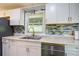 Well-lit kitchen featuring stylish countertops, stainless steel appliances, and modern cabinetry at 3627 Groovers Lake Rd, Lithia Springs, GA 30122