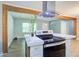 Well-lit kitchen island with stone counters, stainless appliances, and wood beam accents at 3627 Groovers Lake Rd, Lithia Springs, GA 30122