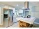Bright kitchen showcases stainless appliances, white cabinetry, granite countertops, and stylish backsplash at 3627 Groovers Lake Rd, Lithia Springs, GA 30122
