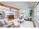 Open-concept living space boasts a modern design with hardwood floors, a plush sofa, and seamless flow into the kitchen at 3627 Groovers Lake Rd, Lithia Springs, GA 30122