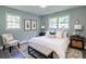 Bright main bedroom with a queen size bed, sitting chair and two large windows at 3627 Groovers Lake Rd, Lithia Springs, GA 30122