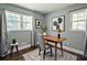 Bright office featuring large windows, neutral walls, modern art, and a simple wood desk with a gray chair at 3627 Groovers Lake Rd, Lithia Springs, GA 30122