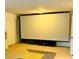 Finished basement with a large projection screen and neutral carpet at 4260 Hammond Bridge Dr, Suwanee, GA 30024