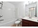 Cozy bathroom featuring a shower-tub combo, white tile backsplash, and a single sink vanity at 4260 Hammond Bridge Dr, Suwanee, GA 30024