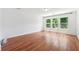Bright and spacious bedroom featuring hardwood floors and natural light from a large window at 4260 Hammond Bridge Dr, Suwanee, GA 30024