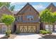 Charming brick townhome featuring a two-car garage and well-maintained landscaping at 4260 Hammond Bridge Dr, Suwanee, GA 30024