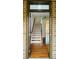 View of the foyer with wood flooring, a staircase with wood and white risers, and an open floor plan at 4260 Hammond Bridge Dr, Suwanee, GA 30024
