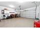 Spacious two-car garage with overhead door, storage cabinets, and epoxy flooring at 4260 Hammond Bridge Dr, Suwanee, GA 30024